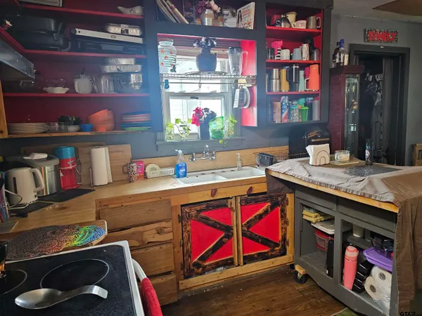 a kitchen with granite countertop a stove a sink and a dishwasher