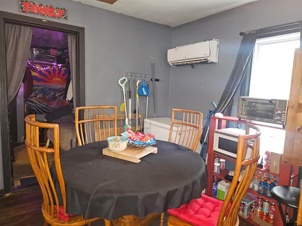 a bedroom with a bed next to a window