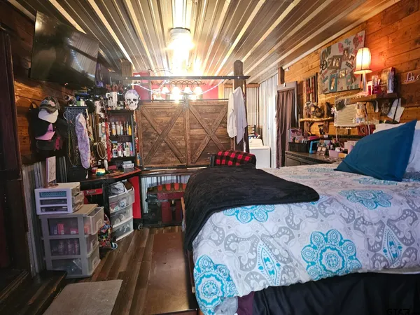 a bedroom with a bed and furniture