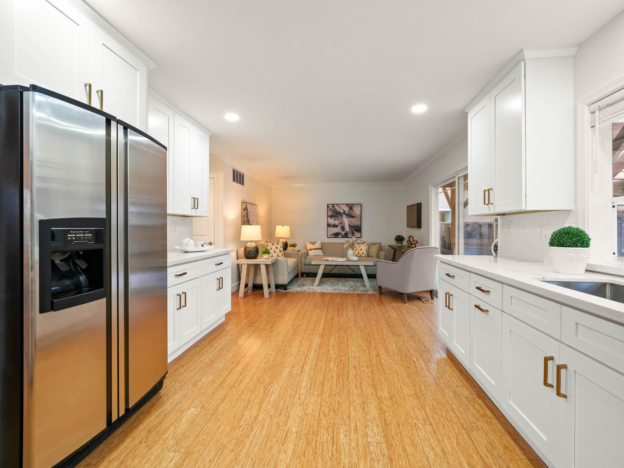 3433 Surry Place Fremont, CA 94536 - Photo 19 of 53 a kitchen with stainless steel appliances a lot of counter top space and wooden floor