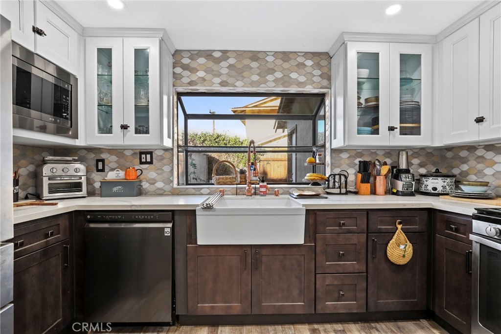 1369 Friant Avenue Simi Valley, CA 93065 - Photo 11 of 38 a kitchen with stainless steel appliances granite countertop a stove a sink and a microwave