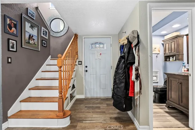 a view of entryway with stairs and wooden floor