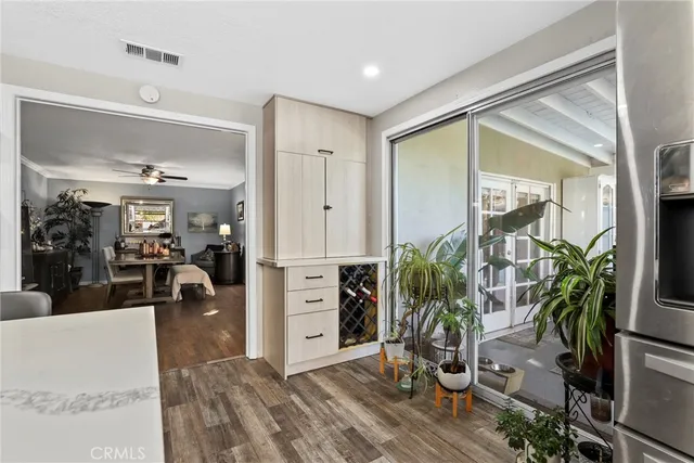 a bedroom with a bed and a flat tv screen on the dresser