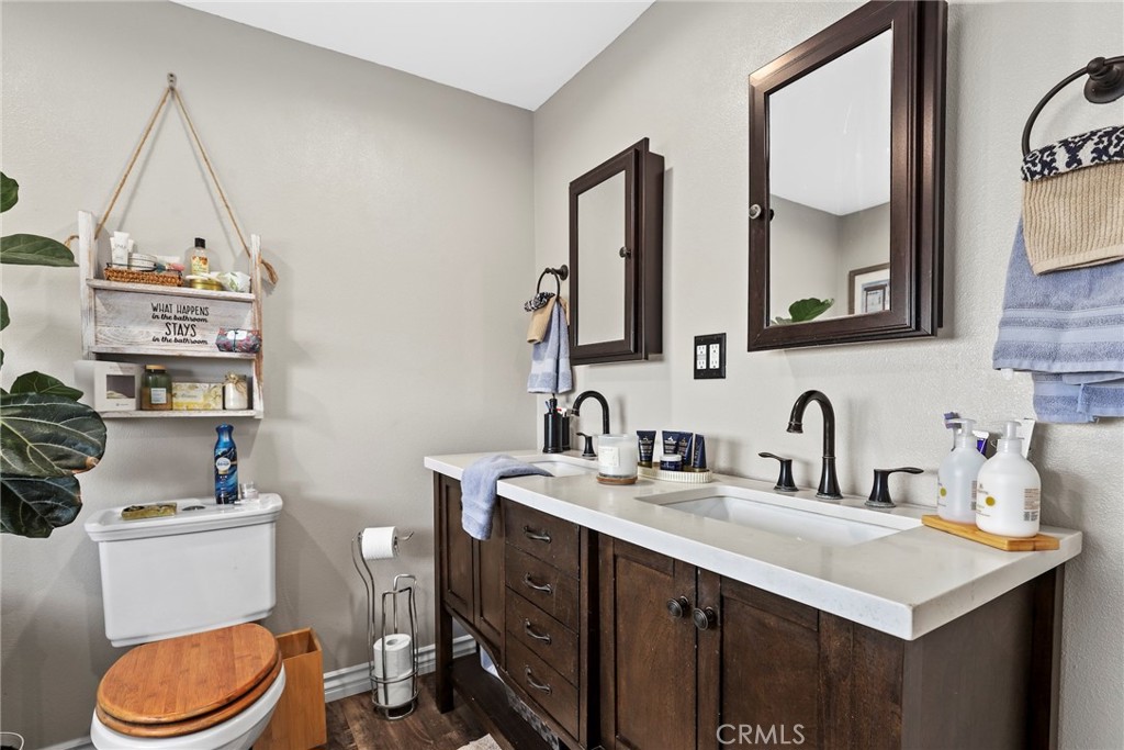 1369 Friant Avenue Simi Valley, CA 93065 - Photo 25 of 38 a bathroom with a toilet a sink a mirror and a window