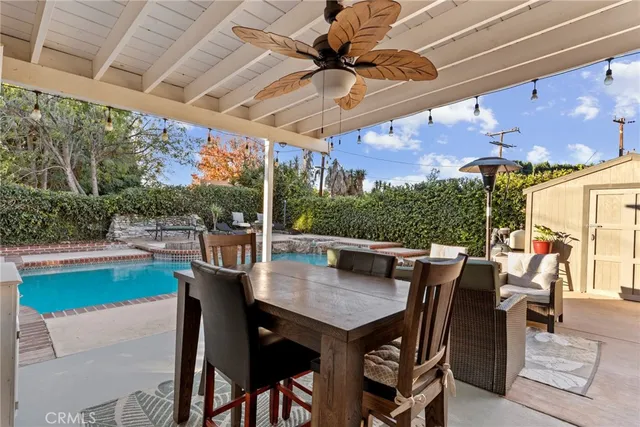 a view of a patio with table and chairs potted plants with wooden floor