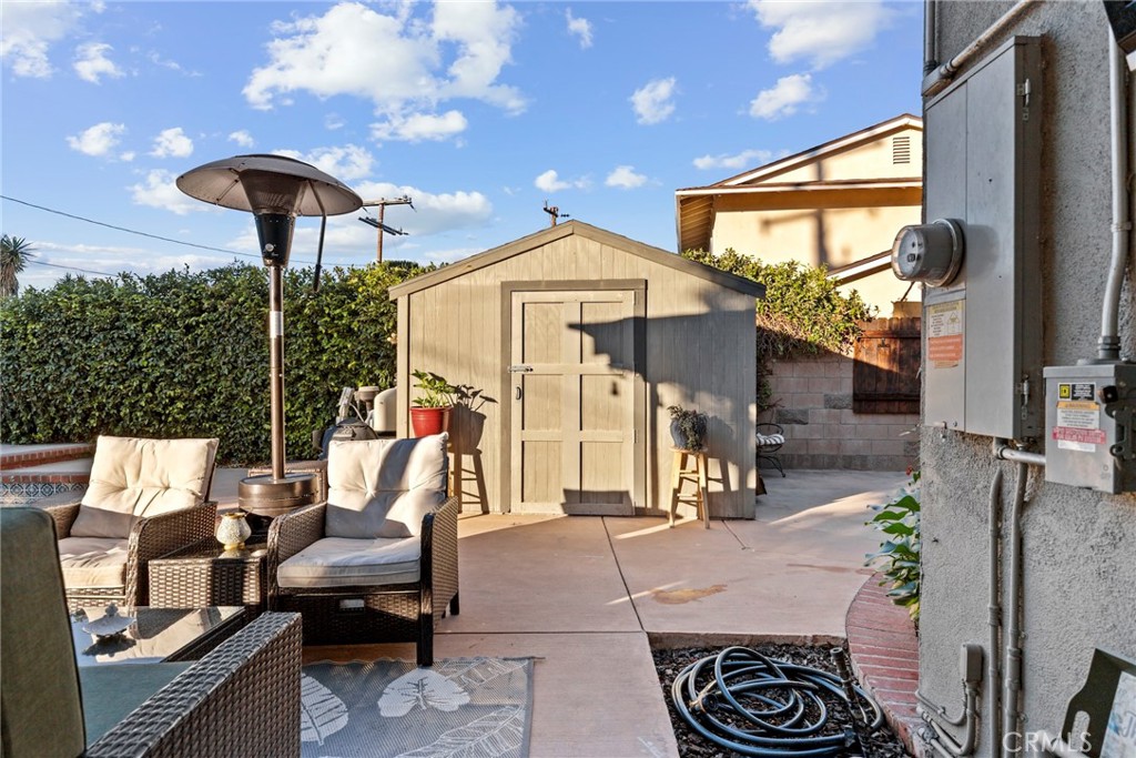 1369 Friant Avenue Simi Valley, CA 93065 - Photo 29 of 38 a view of a patio with table and chairs potted plants with wooden floor