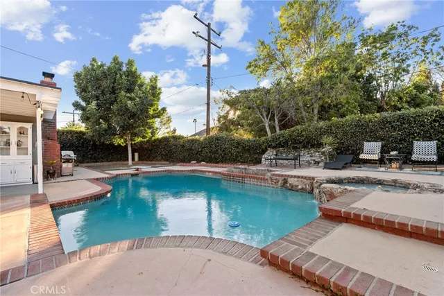 a view of a swimming pool with outdoor seating