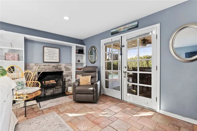 a living room with furniture a window and a fireplace