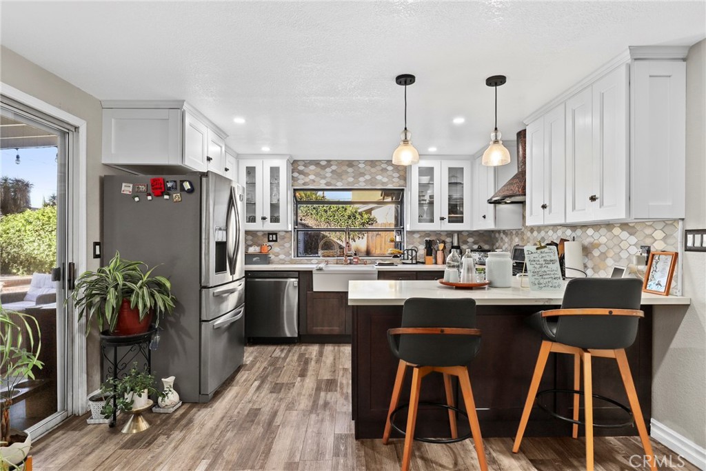 1369 Friant Avenue Simi Valley, CA 93065 - Photo 8 of 38 a kitchen with kitchen island a counter space a sink appliances and cabinets