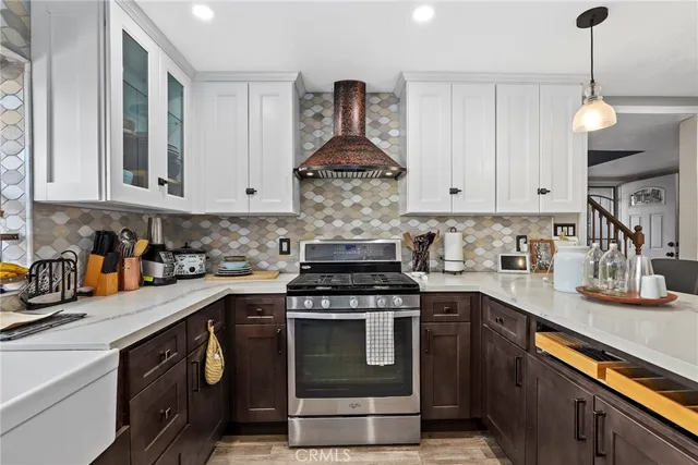 a kitchen with stainless steel appliances granite countertop a stove and cabinets