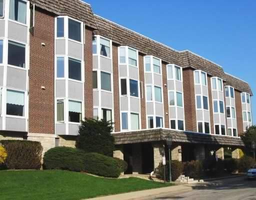 2500 Archbury Lane, Unit 2B Park Ridge, IL 60068 - Photo 1 of 1 a front view of a building with a garden