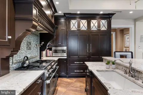 a kitchen with stainless steel appliances a stove sink and cabinets