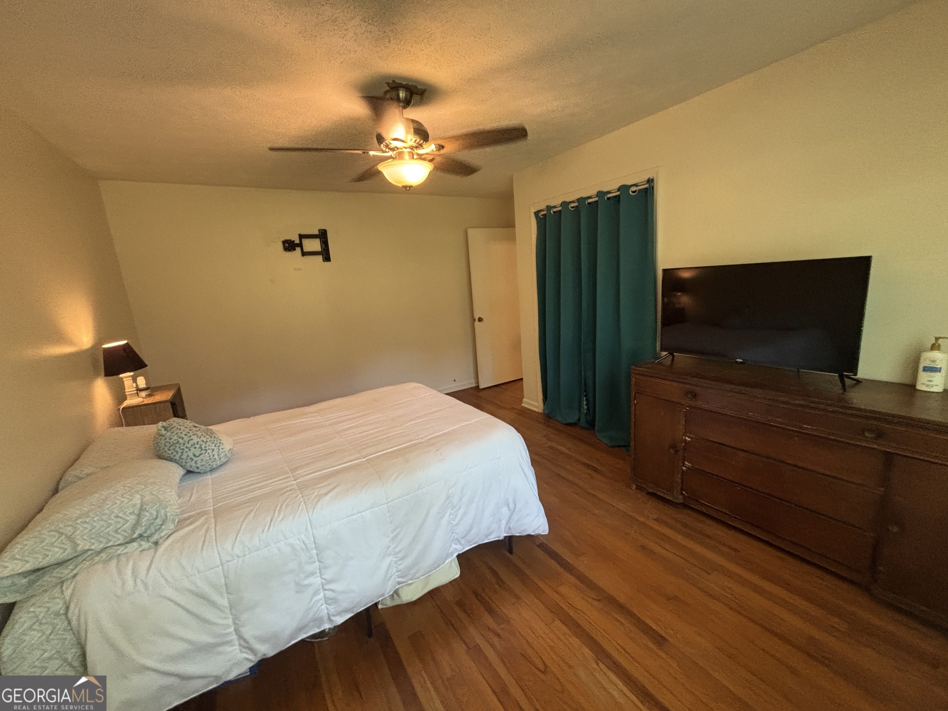 152 Crest Drive Cochran, GA 31014 - Photo 28 of 54 a bedroom with a bed and wooden floor