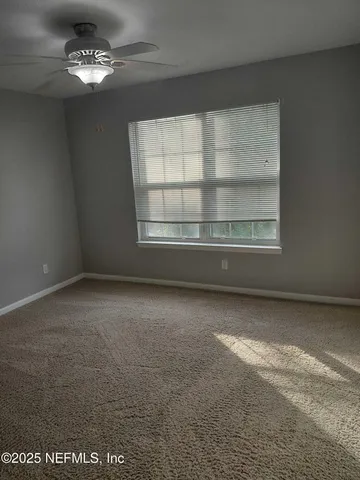 an empty room with a empty space and windows
