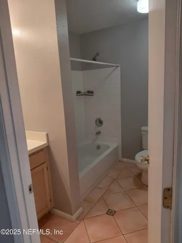 a bathroom with a shower and a toilet