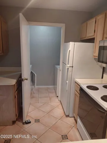 a utility room with cabinets washer and dryer