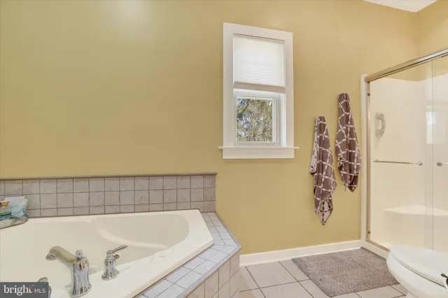 a bathroom with a bathtub and shower