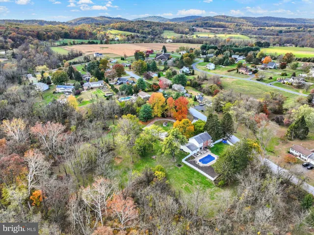an aerial view of a house with a yard and garden
