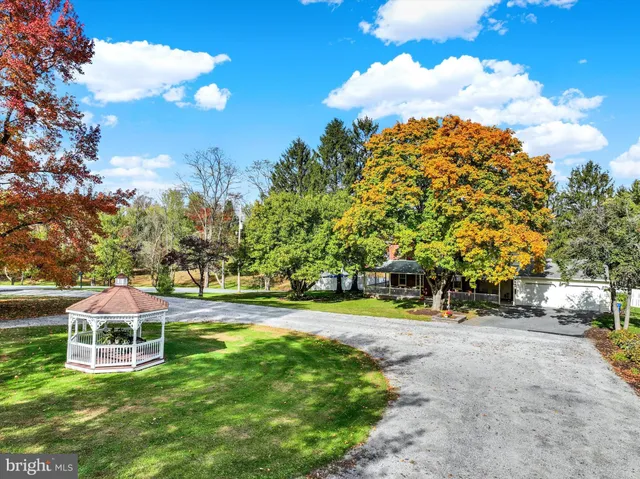a view of a childrens park with large trees