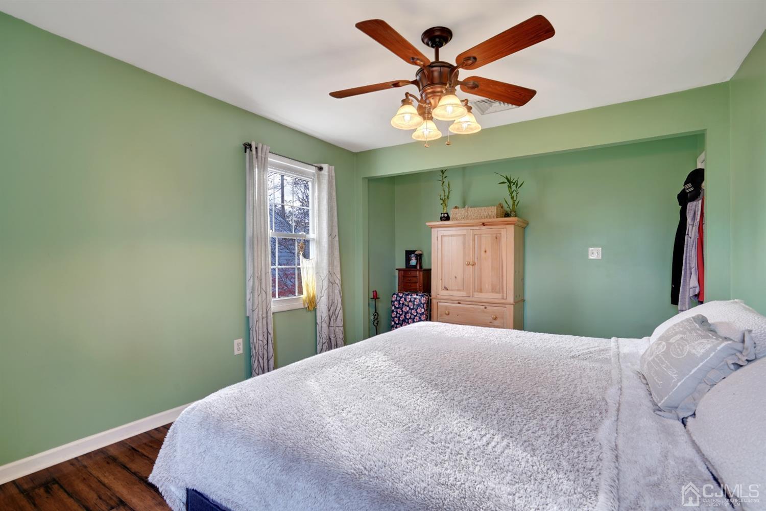 85 Old Post Road Edison, NJ 08817 - Photo 15 of 35 a bedroom with a large bed and a chandelier