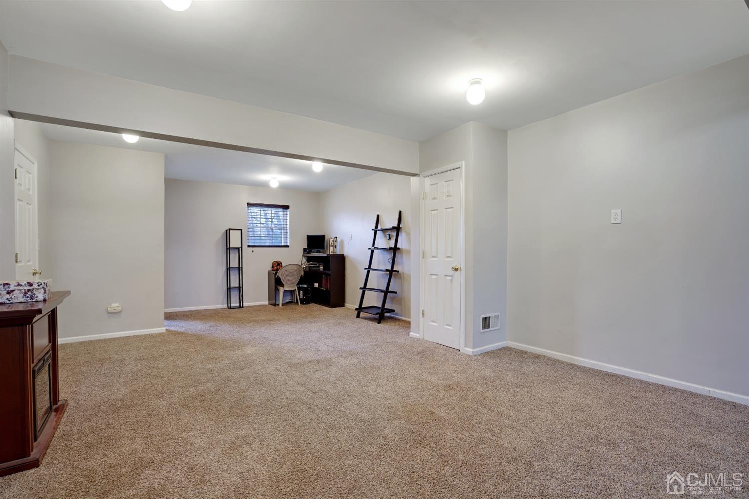 85 Old Post Road Edison, NJ 08817 - Photo 22 of 35 an empty room with furniture and a flat screen tv