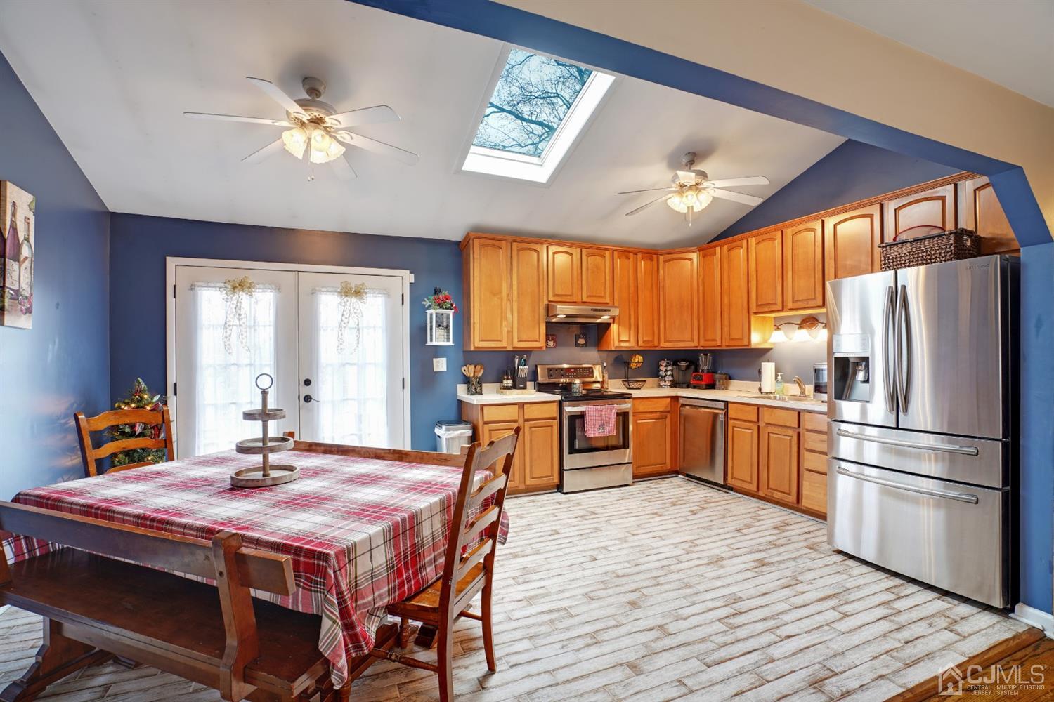 85 Old Post Road Edison, NJ 08817 - Photo 7 of 35 a kitchen with stainless steel appliances granite countertop a refrigerator a sink dishwasher a stove and a dining table with wooden floor