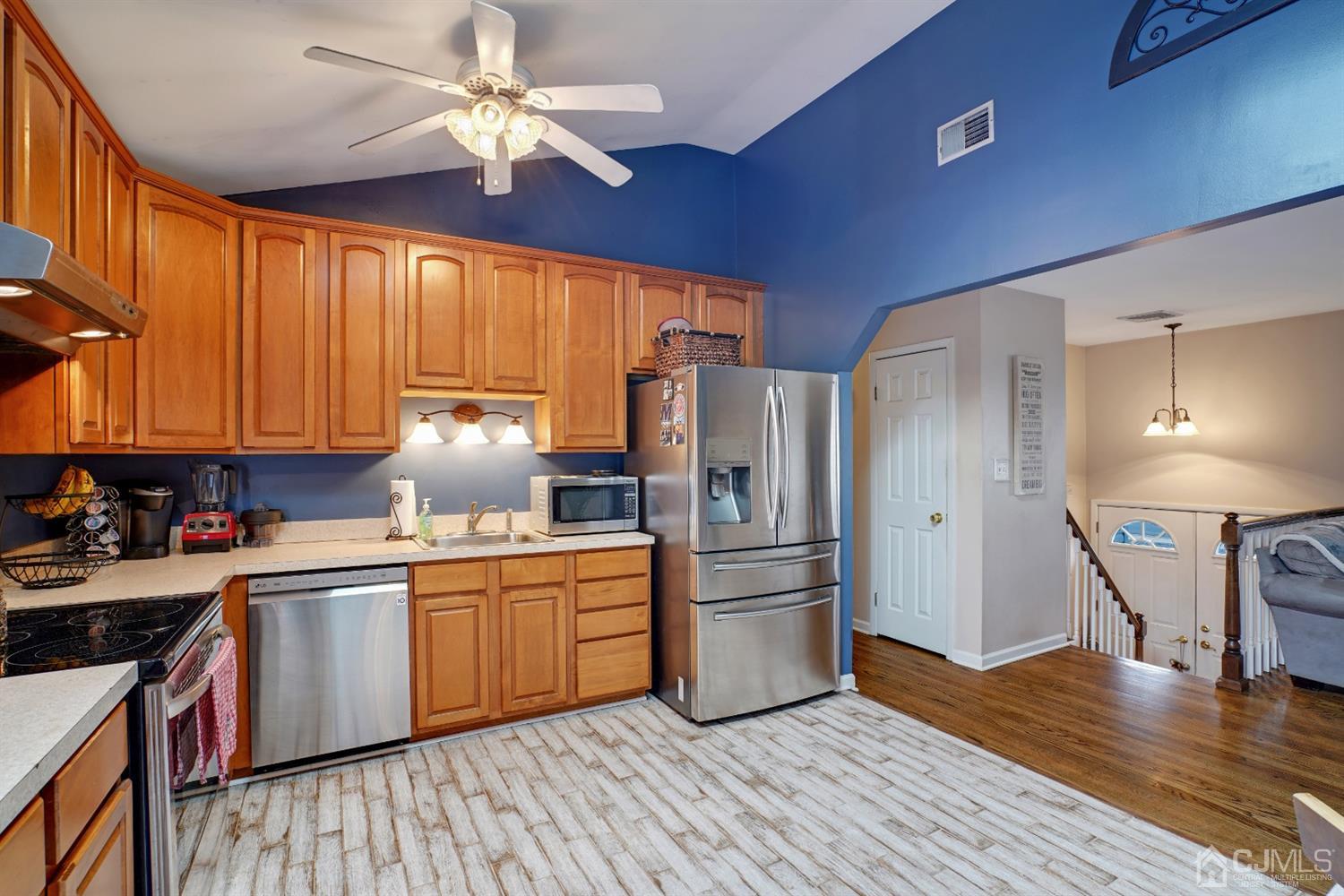85 Old Post Road Edison, NJ 08817 - Photo 9 of 35 a kitchen with stainless steel appliances a stove a refrigerator cabinets and wooden floor