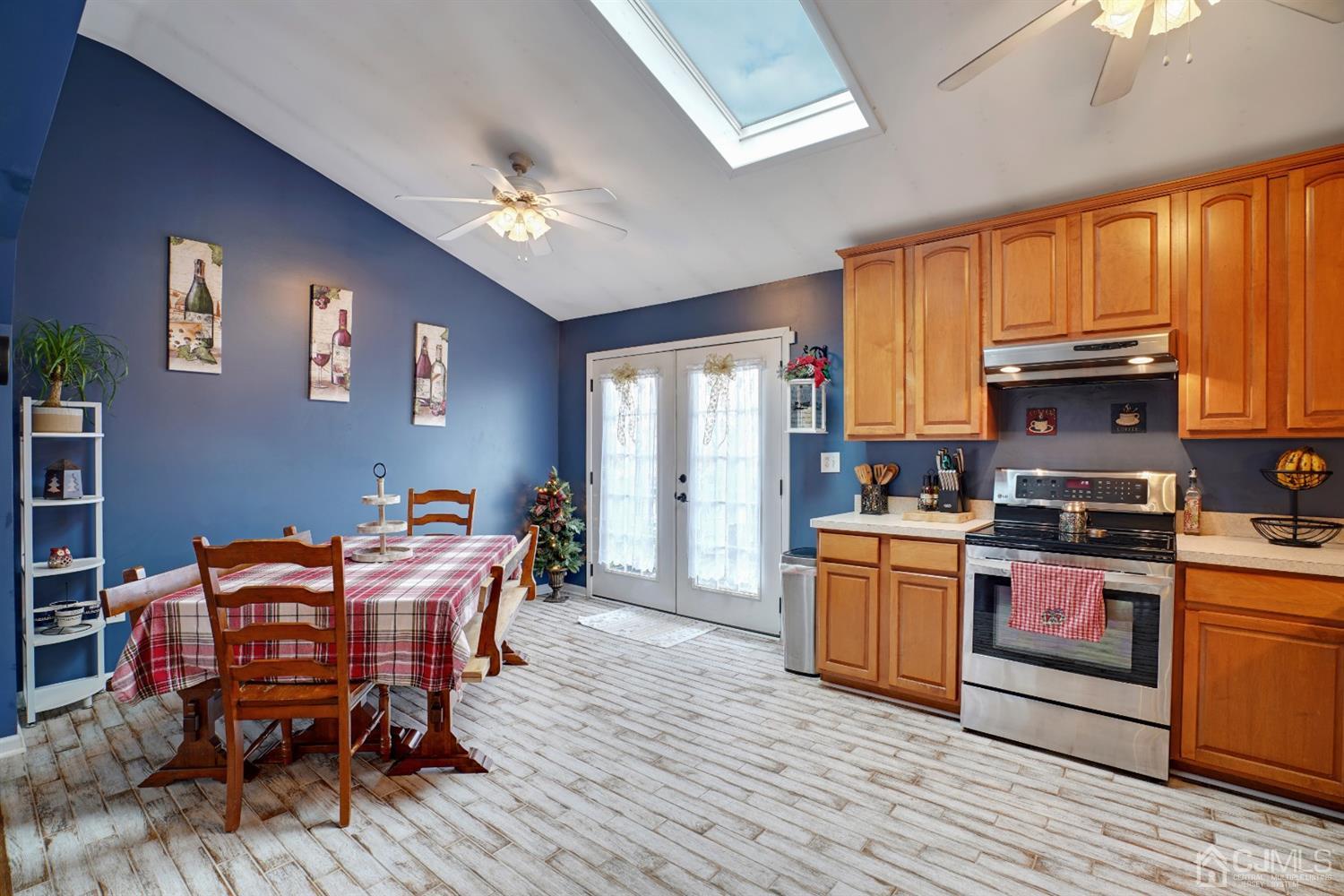 85 Old Post Road Edison, NJ 08817 - Photo 10 of 35 a kitchen with stainless steel appliances granite countertop a stove top oven a refrigerator a dining table and chairs with wooden floor