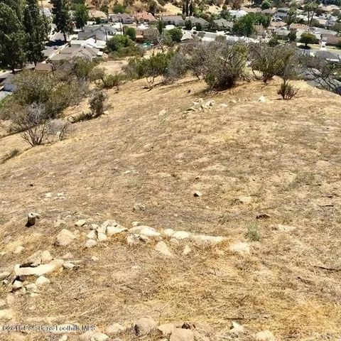 a view of a yard with snow on the road