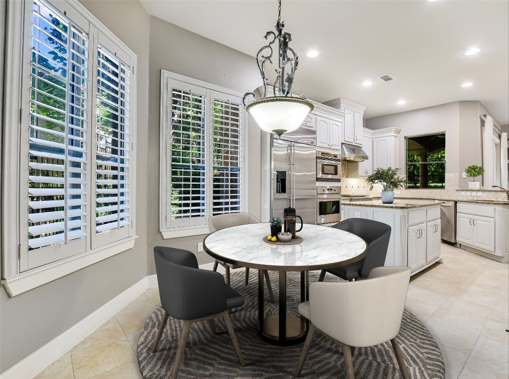 1036 Liberty Park Drive, Unit 54 Austin, TX 78746 - Photo 11 of 24 a dining room with furniture a chandelier and window