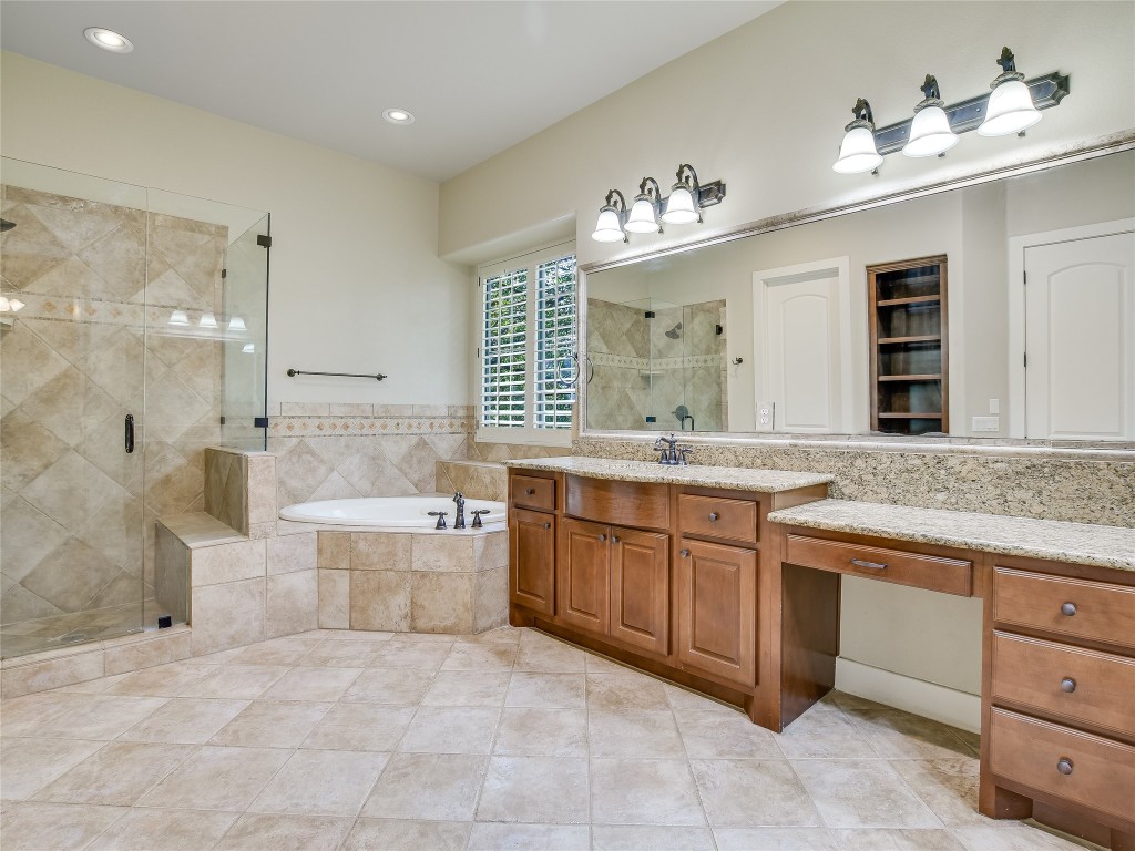 1036 Liberty Park Drive, Unit 54 Austin, TX 78746 - Photo 14 of 24 a large bathroom with a granite countertop double vanity sink a bathtub and shower