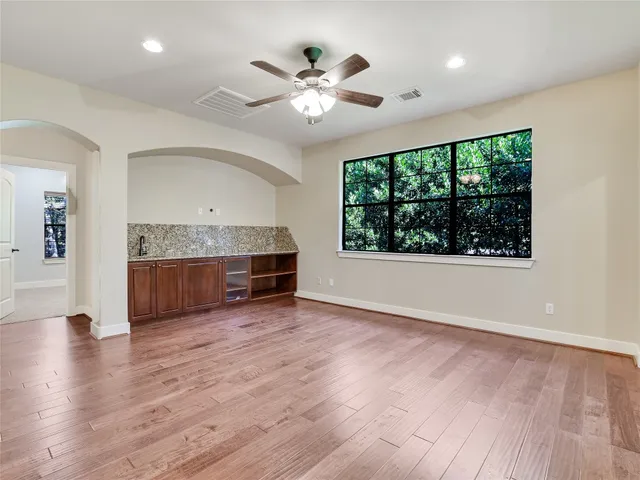 a kitchen with stainless steel appliances granite countertop a stove a sink and a large window