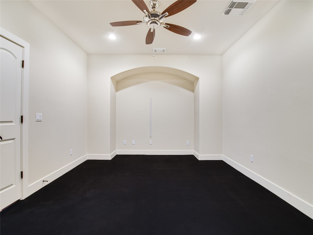 1036 Liberty Park Drive, Unit 54 Austin, TX 78746 - Photo 16 of 24 an empty room with wooden floor fan and windows