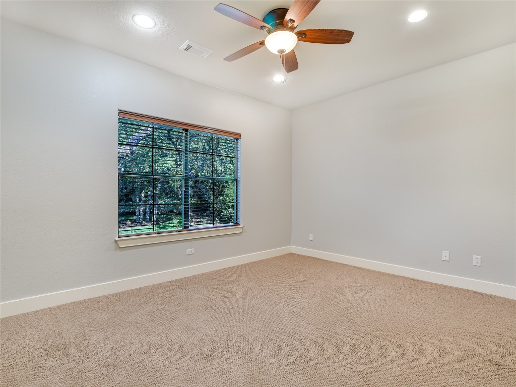 1036 Liberty Park Drive, Unit 54 Austin, TX 78746 - Photo 17 of 24 an empty room with a window and a fan