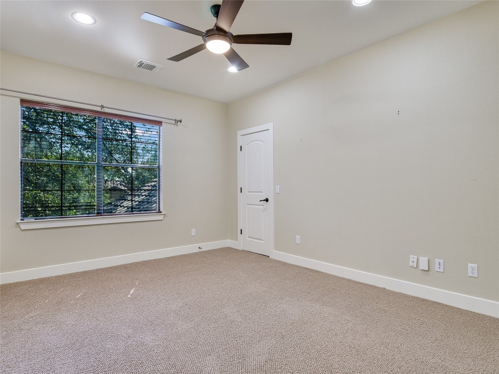 1036 Liberty Park Drive, Unit 54 Austin, TX 78746 - Photo 20 of 24 an empty room with a window and a ceiling fan