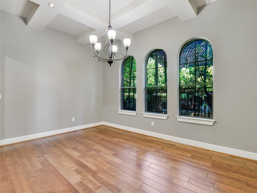 1036 Liberty Park Drive, Unit 54 Austin, TX 78746 - Photo 3 of 24 a view of a room with wooden floors a chandelier and a window