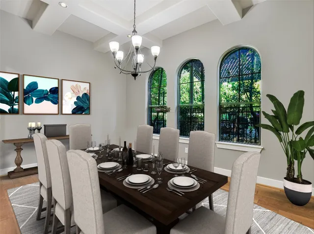 a view of a dining room with furniture a chandelier and window