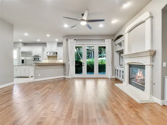a view of an empty room with a fireplace and a window