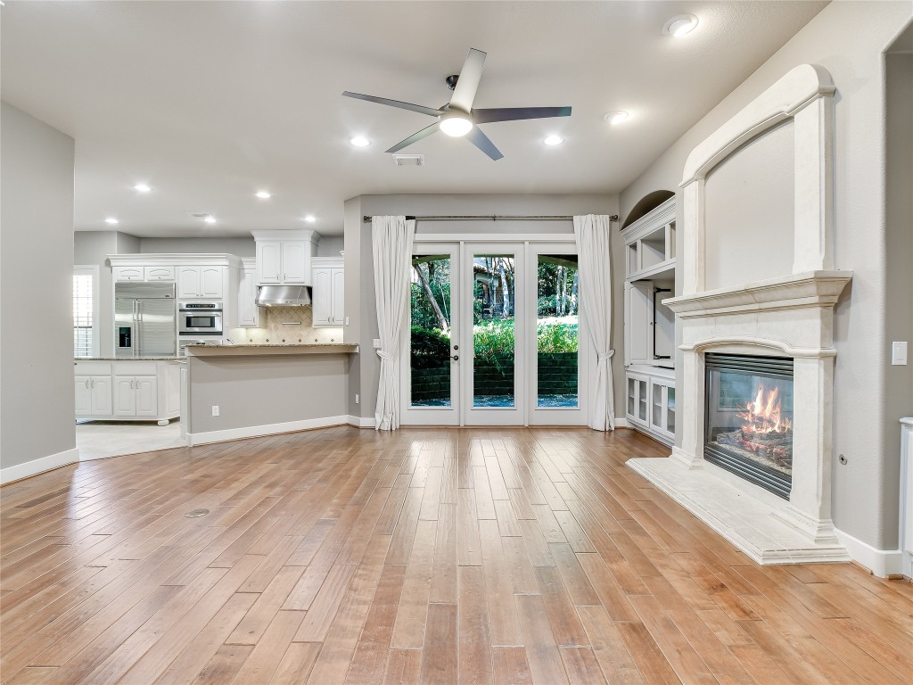 1036 Liberty Park Drive, Unit 54 Austin, TX 78746 - Photo 5 of 24 a view of an empty room with a fireplace and a window