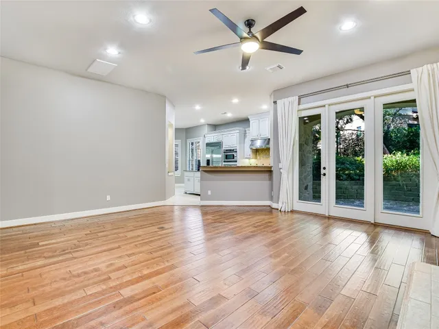 wooden floor in an empty room with a kitchen