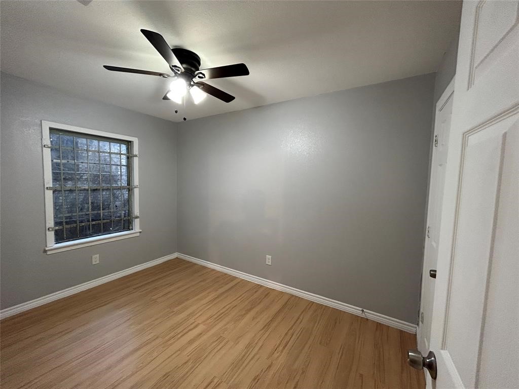 6818 Weston Street, Unit 1 Houston, TX 77021 - Photo 7 of 10 a view of an empty room with wooden floor and a window