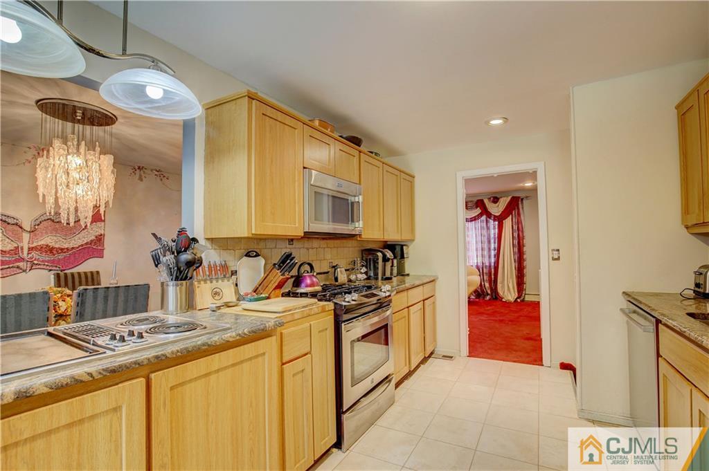 3 Pendleton Place Edison, NJ 08820 - Photo 11 of 47 a kitchen that has a lot of cabinets in it