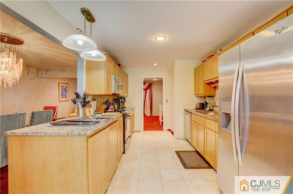 3 Pendleton Place Edison, NJ 08820 - Photo 13 of 47 a kitchen with stainless steel appliances granite countertop a sink and cabinets