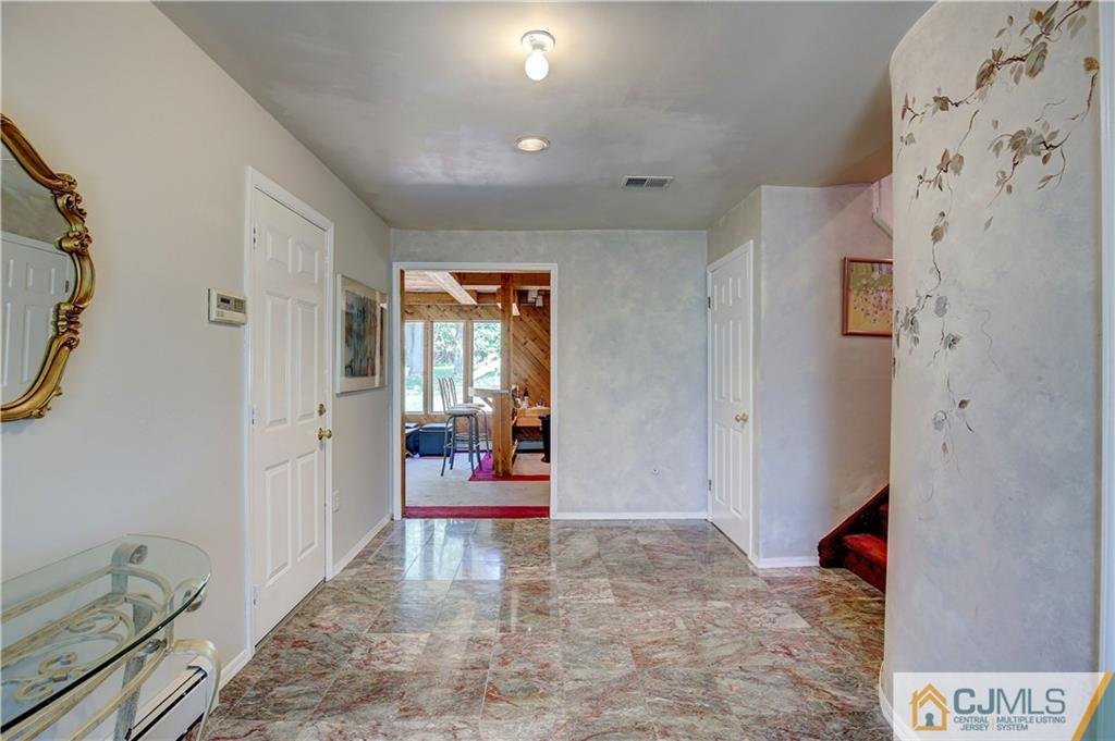 3 Pendleton Place Edison, NJ 08820 - Photo 4 of 47 a view of a hallway with dining area and glass door