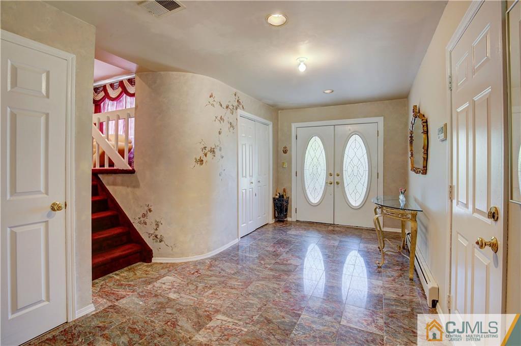 3 Pendleton Place Edison, NJ 08820 - Photo 5 of 47 a view of a hallway with wooden floor and entryway