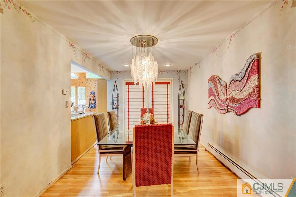 3 Pendleton Place Edison, NJ 08820 - Photo 10 of 47 a view of a dining room with furniture and a chandelier
