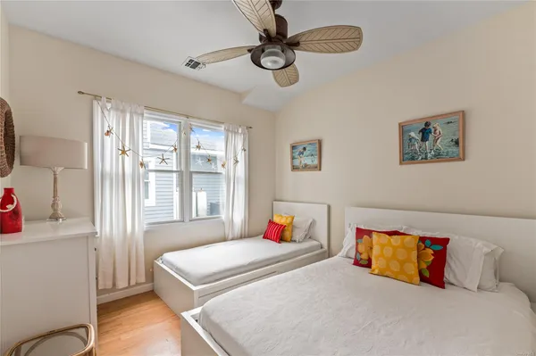 a bedroom with a bed dresser and a window