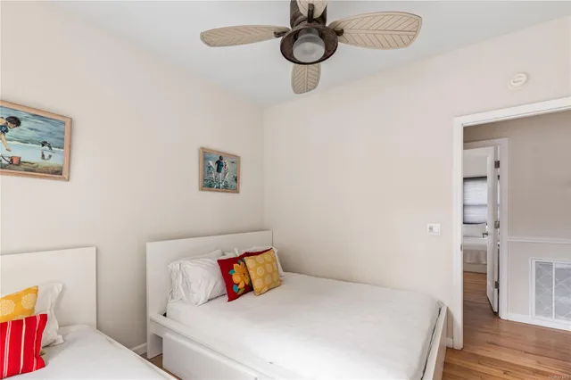 a bedroom with a bed and painting on the wall