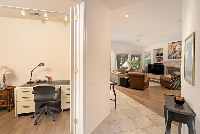 a view of a workspace with furniture and a flat screen tv