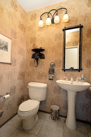 a bathroom with a toilet sink and mirror